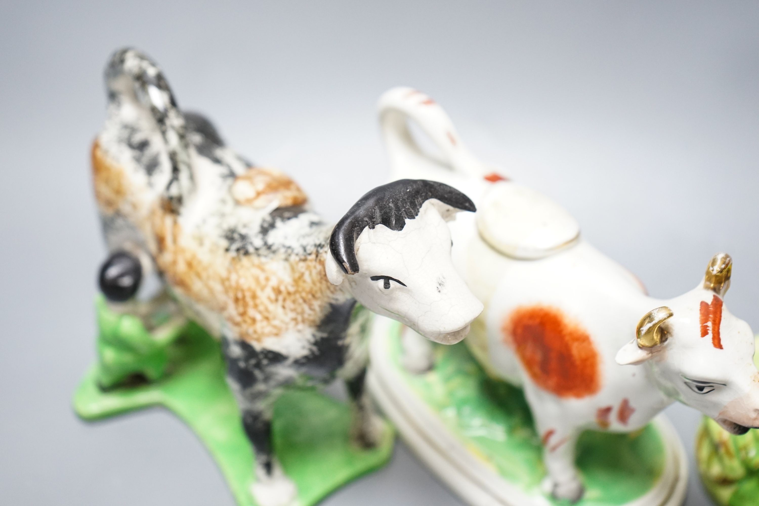 A 19th century 'Milkmaid and cow' creamer with sponged decoration, three other Staffordshire items and a Continental majolica figure of a turkey (5)